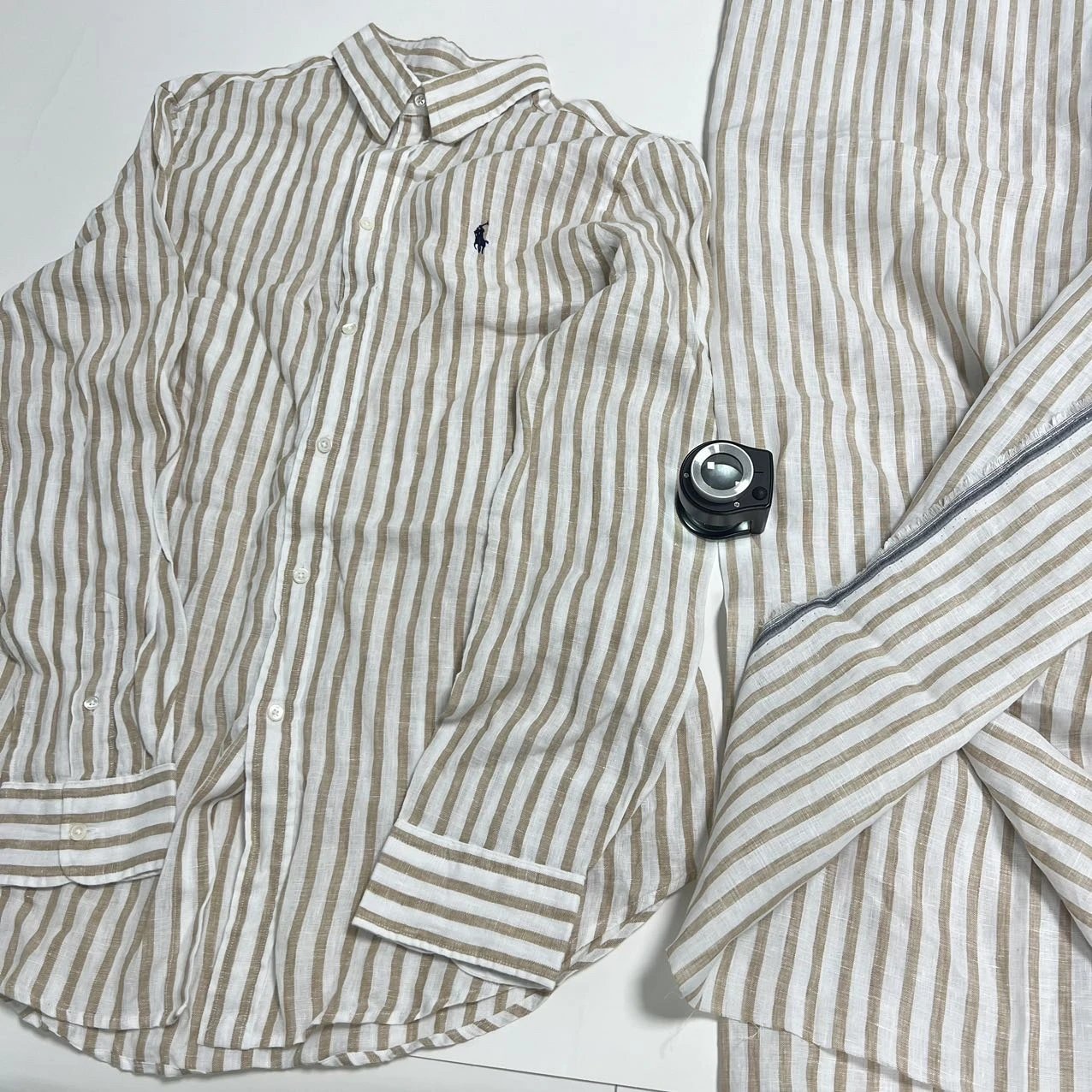 Striped shirt and magnifier